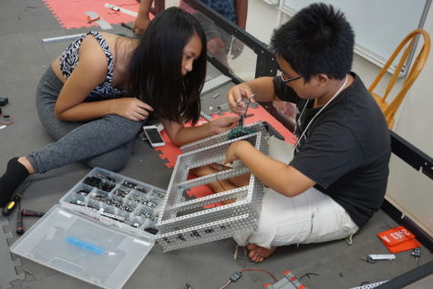NHIS Robotics students work on building a robot.