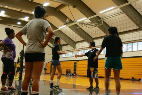 Jubei Wong, NHIS Varsity Volleyball coach, gives his players instructions.