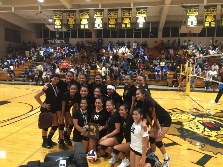 The Varsity Girls Volleyball team pose after winning the championship.