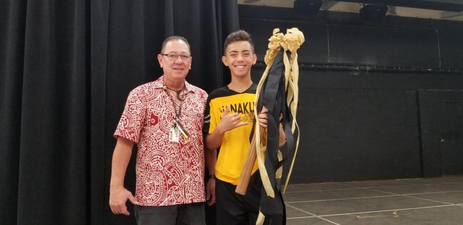 Phillip+Morales%2C+Freshmen+Class+advisor%2C+and+Sammy+Kea%2C+Freshmen+Class+President%2C+hold+the+Spirit+Stick+after+their+class+win+in+the+Penny+War+competition.