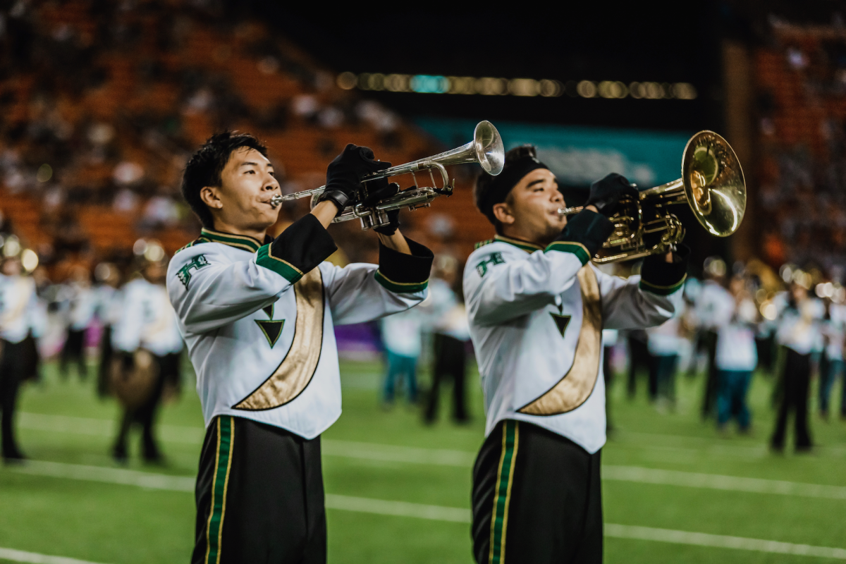 New Band director Tate Sakamoto (left) is an accomplished trumpet player and experienced in marching band from high school to college to national drum and bugle corps.