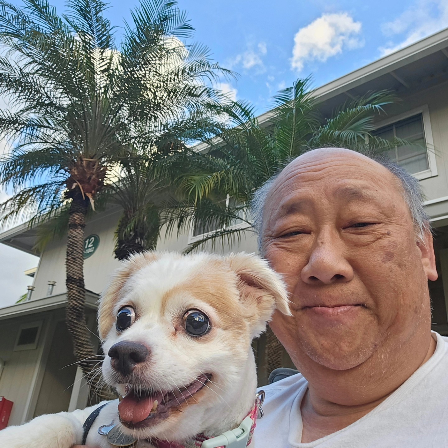 Gerald Lum with his dog, Bailey, will retire after 33 years at NHIS.